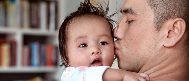 Un papa embrassant son bébé après le bain